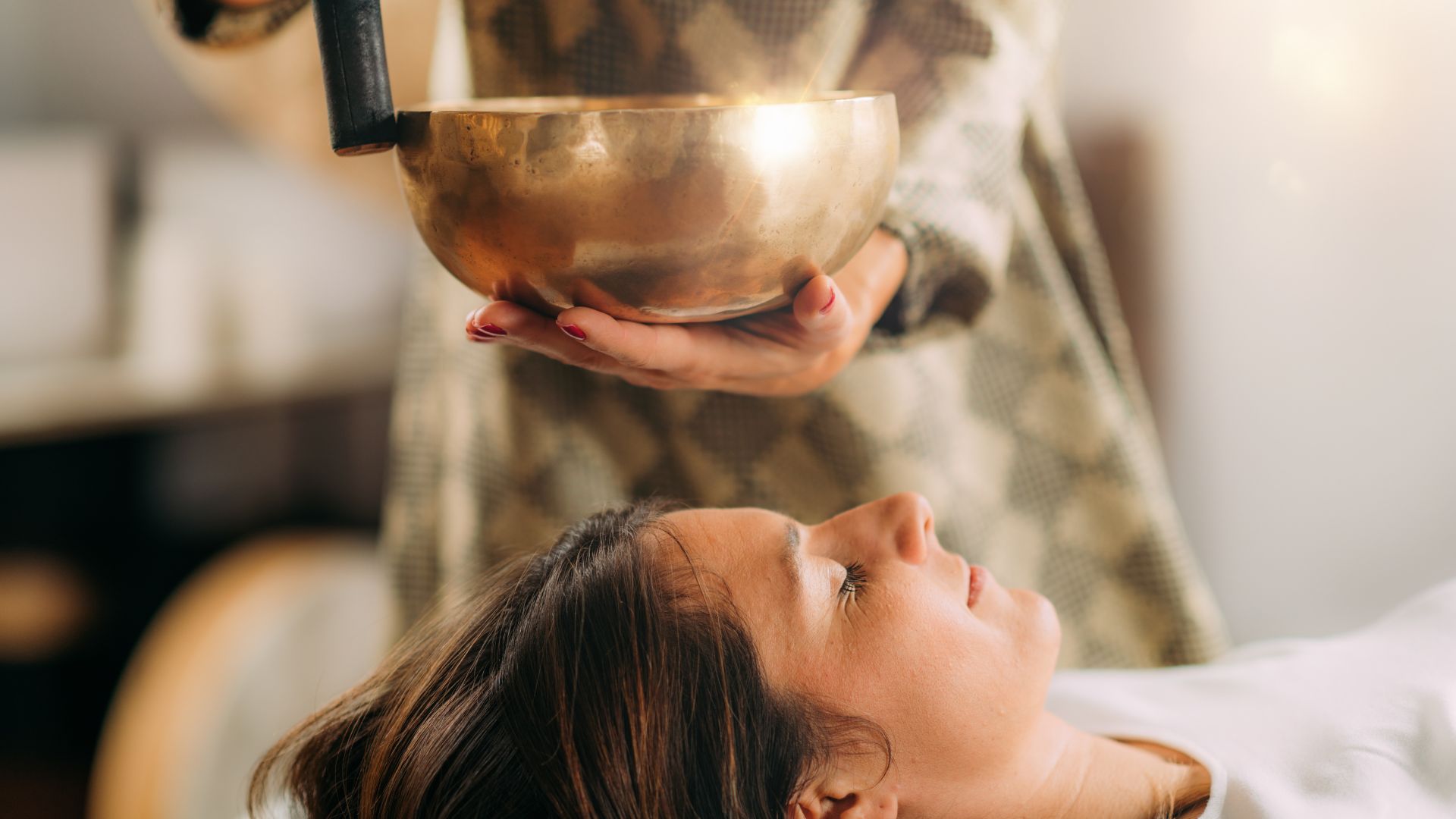 A woman getting her hair brushed by a hair dryer